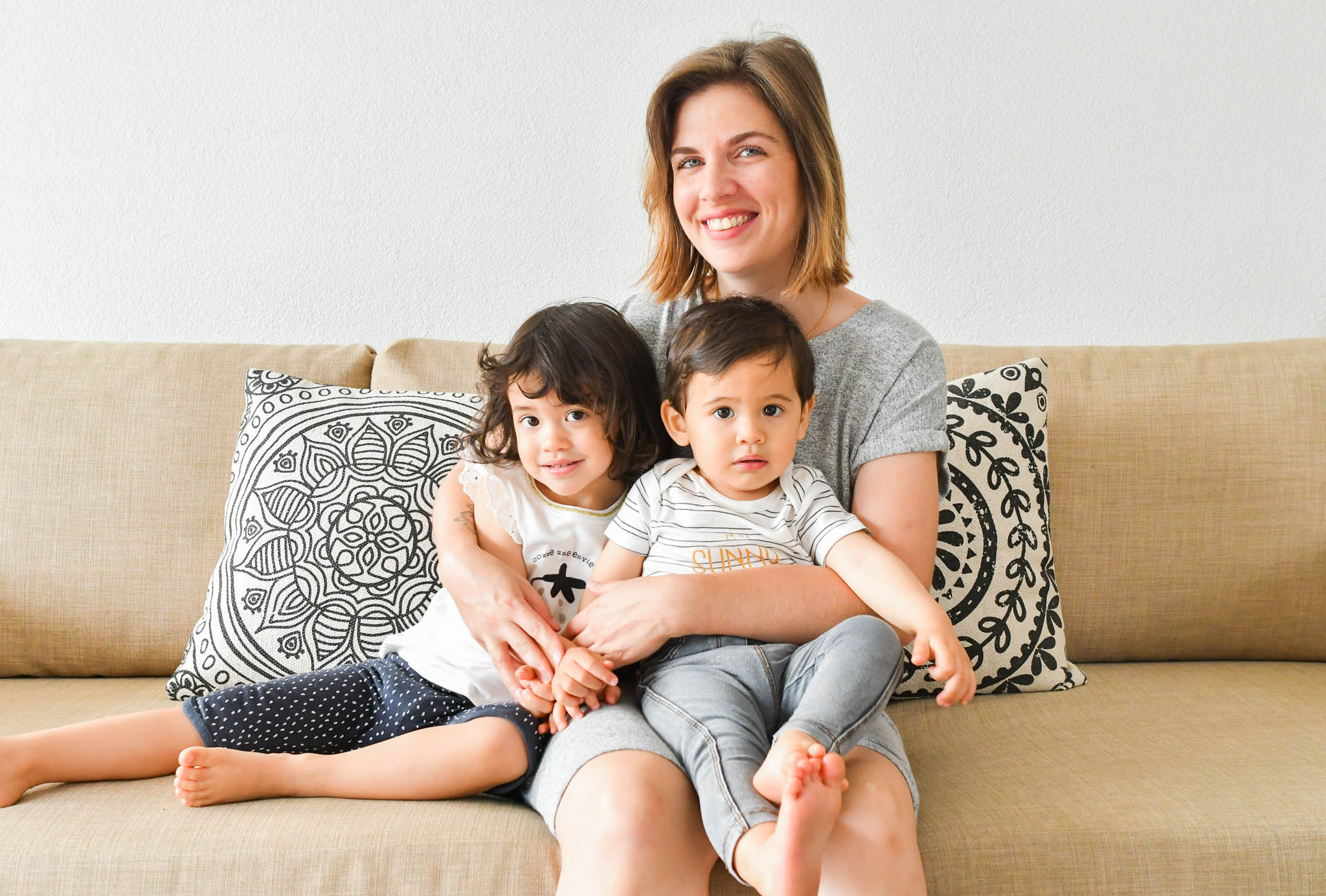 Laetitia and her children on the sofa in the living room.