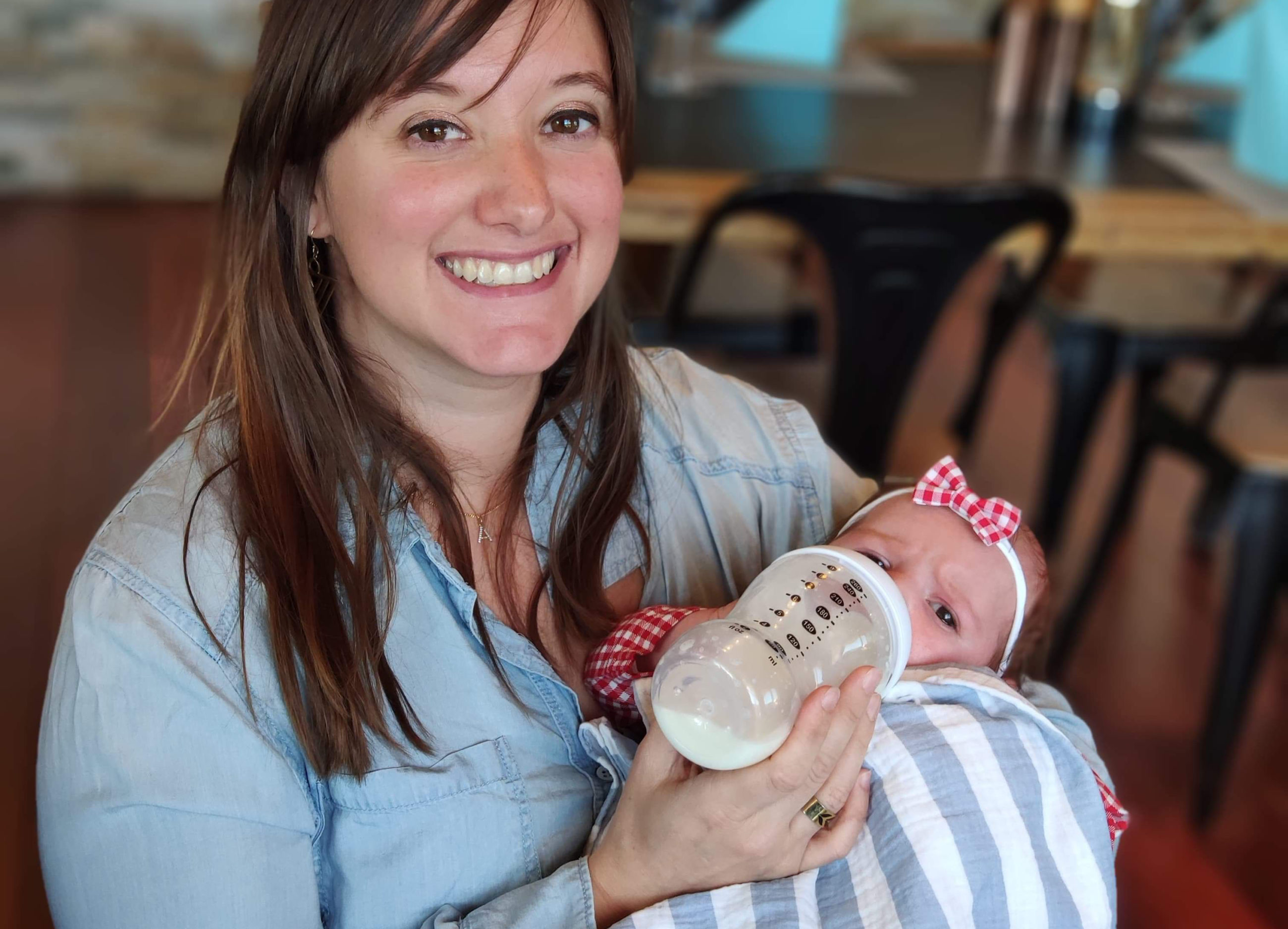 Karine bottle-feeding her daughter